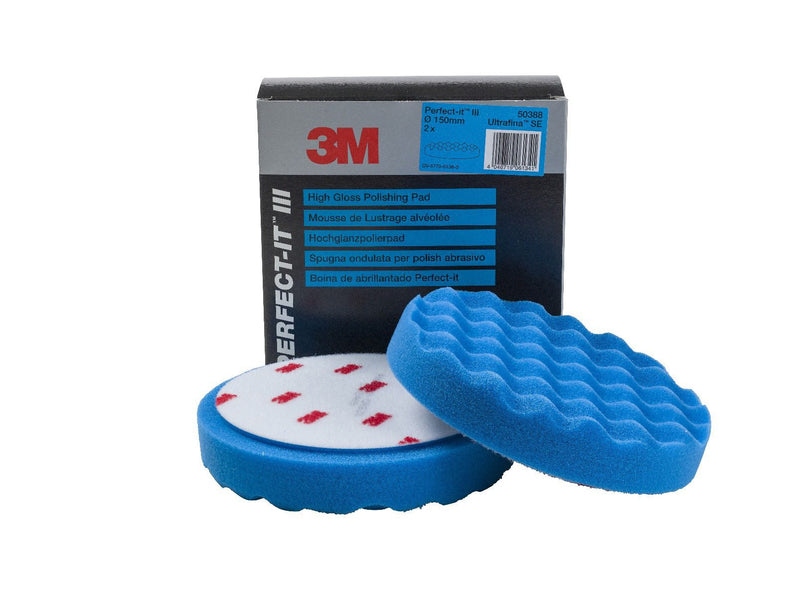 A 3M Perfect-It Ultrafine Polishing Pad in blue color, packaged in a black box with the product branding visible.