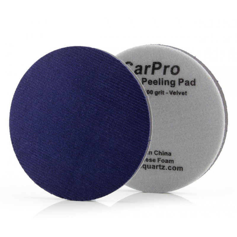 A denim blue colored peel removal pad, with a grey packaging that has 'CarPro Peeling Pad' and '800 grit velvet' printed on it.
