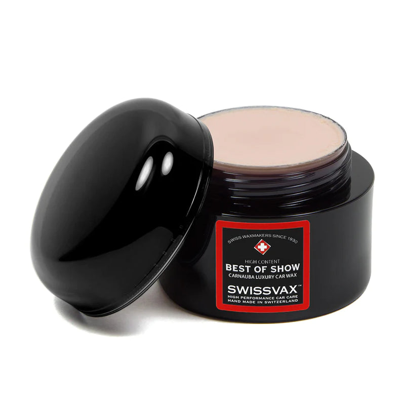 A round black container with a lid, labeled 'Swissvax Best of Show Wax' with a transparent band showing the product color.