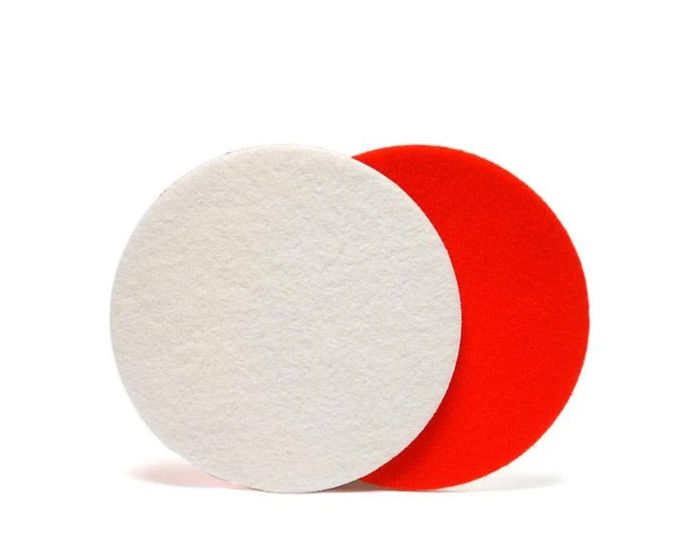 Two round glass cutting pads, one white and one red, with a hook and loop backing visible.